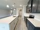 Modern kitchen featuring navy blue cabinets, white quartz countertops, a stainless steel oven, and an island with sink at 1237 Fern Ridge Ct # 18, Norcross, GA 30093
