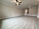 Spacious living room with gray wood-look floors, a ceiling fan, and plenty of natural light at 1237 Fern Ridge Ct # 18, Norcross, GA 30093