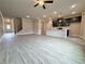 Open-concept living space with grey flooring flowing into the kitchen with a large island and navy cabinets at 1237 Fern Ridge Ct # 18, Norcross, GA 30093