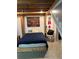 Modern bedroom with exposed wooden beams, concrete flooring, and eclectic artwork at 170 Boulevard Se # H414, Atlanta, GA 30312