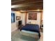 Modern bedroom with exposed wooden beams, concrete flooring, and eclectic artwork at 170 Boulevard Se # H414, Atlanta, GA 30312