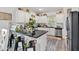 Modern kitchen featuring white cabinetry, a large island, stainless steel appliances, and sleek countertops at 173 Bramlett Ridge Dr, Dallas, GA 30157