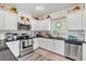 Bright kitchen featuring white cabinets, stainless steel appliances, and stylish decor for a cozy feel at 173 Bramlett Ridge Dr, Dallas, GA 30157