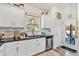Bright kitchen with white cabinets, stainless steel appliances, and an adjacent door leading to the backyard at 173 Bramlett Ridge Dr, Dallas, GA 30157