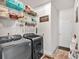 Laundry room with washer, dryer, storage shelves, and ample space at 173 Bramlett Ridge Dr, Dallas, GA 30157