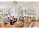 Open-concept living space showcasing hardwood floors, stylish decor, and comfortable seating with views into the dining area at 173 Bramlett Ridge Dr, Dallas, GA 30157
