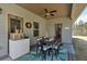 Inviting covered patio with outdoor dining, ceiling fan and wooded views at 173 Bramlett Ridge Dr, Dallas, GA 30157