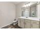 Bright bathroom featuring a modern vanity with white countertop and wood-look flooring at 1602 Dover Creek Ln, Lawrenceville, GA 30045