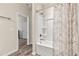 Well-lit bathroom showcasing a white tub and shower combination with a patterned curtain at 1602 Dover Creek Ln, Lawrenceville, GA 30045
