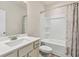 Functional bathroom with a sleek vanity, toilet, and shower-tub combination at 1602 Dover Creek Ln, Lawrenceville, GA 30045