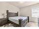 Comfortable bedroom with wood-look flooring, a well-appointed bed, a dresser, and a window for natural light at 1602 Dover Creek Ln, Lawrenceville, GA 30045