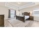 Spacious bedroom boasts tray ceiling, large window, and stylish furniture with a luxurious rug accenting the floor at 1602 Dover Creek Ln, Lawrenceville, GA 30045