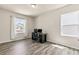Comfortable bedroom setup with desk and two windows, complemented by wood-look flooring at 1602 Dover Creek Ln, Lawrenceville, GA 30045