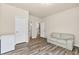Bonus room area with several entry doors is displayed with modern furniture and wood flooring at 1602 Dover Creek Ln, Lawrenceville, GA 30045