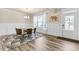 Elegant dining area with wainscoting, stylish rug, and a modern chandelier, adjacent to the entryway at 1602 Dover Creek Ln, Lawrenceville, GA 30045