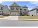 Beautiful two-story home featuring a stone facade, attached two-car garage, and inviting front lawn at 1602 Dover Creek Ln, Lawrenceville, GA 30045