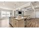 Open concept living space with kitchen island overlooking living room with fireplace and coffered ceilings at 1602 Dover Creek Ln, Lawrenceville, GA 30045