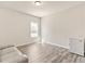 Bonus room with lots of natural light is shown featuring a large window and wood flooring at 1602 Dover Creek Ln, Lawrenceville, GA 30045