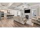 Cozy living room with fireplace, coffered ceiling, and hardwood floors, open to the modern kitchen at 1602 Dover Creek Ln, Lawrenceville, GA 30045