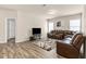 Inviting living room with a plush sectional sofa, TV setup, and stylish wood-look flooring at 1602 Dover Creek Ln, Lawrenceville, GA 30045
