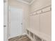 Mudroom features convenient storage including a bench with cubbies, coat hooks and an exterior door at 1602 Dover Creek Ln, Lawrenceville, GA 30045