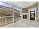 Screened porch with a fireplace, offering a cozy outdoor living space at 1602 Dover Creek Ln, Lawrenceville, GA 30045