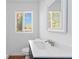 Bathroom with a bright window, single sink and updated finishes at 1907 Clarke Ln, Decatur, GA 30035