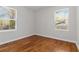 Bedroom featuring hardwood floors and two windows for natural light at 1907 Clarke Ln, Decatur, GA 30035