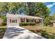 Exterior view with a long driveway leading to a cozy single-story home at 1907 Clarke Ln, Decatur, GA 30035