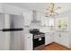 Modern kitchen with stainless steel appliances, white cabinets and subway tile at 1907 Clarke Ln, Decatur, GA 30035