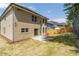 View of the rear of a two-story home with a patio and a fenced yard with newly planted grass at 351 Chandler Bluff Ct, Grayson, GA 30017