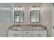 Elegant bathroom featuring double sinks, granite countertops, and modern lighting at 351 Chandler Bluff Ct, Grayson, GA 30017