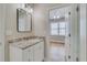 Bathroom features granite countertops, white cabinets, and is located next to a bedroom with hardwood floors at 351 Chandler Bluff Ct, Grayson, GA 30017