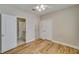 Bright bedroom with light hardwood floors, white trim, and attached bathroom at 351 Chandler Bluff Ct, Grayson, GA 30017