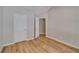 Bright bedroom featuring vaulted ceiling, wood floors, and multiple closets at 351 Chandler Bluff Ct, Grayson, GA 30017