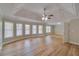 Large bedroom with tray ceiling and hardwood floors, and large windows at 351 Chandler Bluff Ct, Grayson, GA 30017