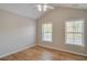 Bright bedroom featuring a ceiling fan, wood-look floors, two windows, and neutral walls at 351 Chandler Bluff Ct, Grayson, GA 30017