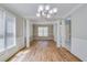 Expansive dining room with hardwood floors, wainscoting, and bright natural lighting at 351 Chandler Bluff Ct, Grayson, GA 30017