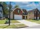 Well-maintained home featuring brick facade, attached two-car garage, and a neatly landscaped lawn at 351 Chandler Bluff Ct, Grayson, GA 30017