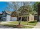 Charming home with a brick facade, an attached garage, and a lush tree in the front yard at 351 Chandler Bluff Ct, Grayson, GA 30017