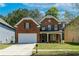 Beautiful two-story brick home with a manicured lawn, two-car garage, and inviting front porch at 351 Chandler Bluff Ct, Grayson, GA 30017