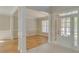 Elegant foyer with hardwood floors, decorative columns, and natural light from the door at 351 Chandler Bluff Ct, Grayson, GA 30017