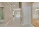 Bright hallway with tile flooring, access to a bathroom, and views of the backyard at 351 Chandler Bluff Ct, Grayson, GA 30017