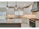 Modern kitchen with granite countertops, white cabinets, stainless steel appliances, and bright pendant lighting at 351 Chandler Bluff Ct, Grayson, GA 30017