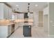 Bright kitchen features white cabinets, stainless steel appliances, and a gray center island with granite countertops at 351 Chandler Bluff Ct, Grayson, GA 30017