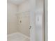 Bright laundry area with white tile flooring, wire shelf, and outlets for washer and dryer hookups at 351 Chandler Bluff Ct, Grayson, GA 30017