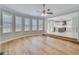 Bright living room with hardwood floors, many windows and an adjacent modern kitchen space at 351 Chandler Bluff Ct, Grayson, GA 30017