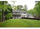 Expansive backyard with a well-maintained lawn, a screened porch, and a large wooden deck at 3562 Sunderland Ne Cir, Atlanta, GA 30319