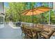 Inviting outdoor dining area on the deck, featuring a grill and large umbrella for shade at 3562 Sunderland Ne Cir, Atlanta, GA 30319