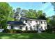 Charming white brick two-story home with dark roof, shuttered windows and well-manicured front lawn at 3562 Sunderland Ne Cir, Atlanta, GA 30319